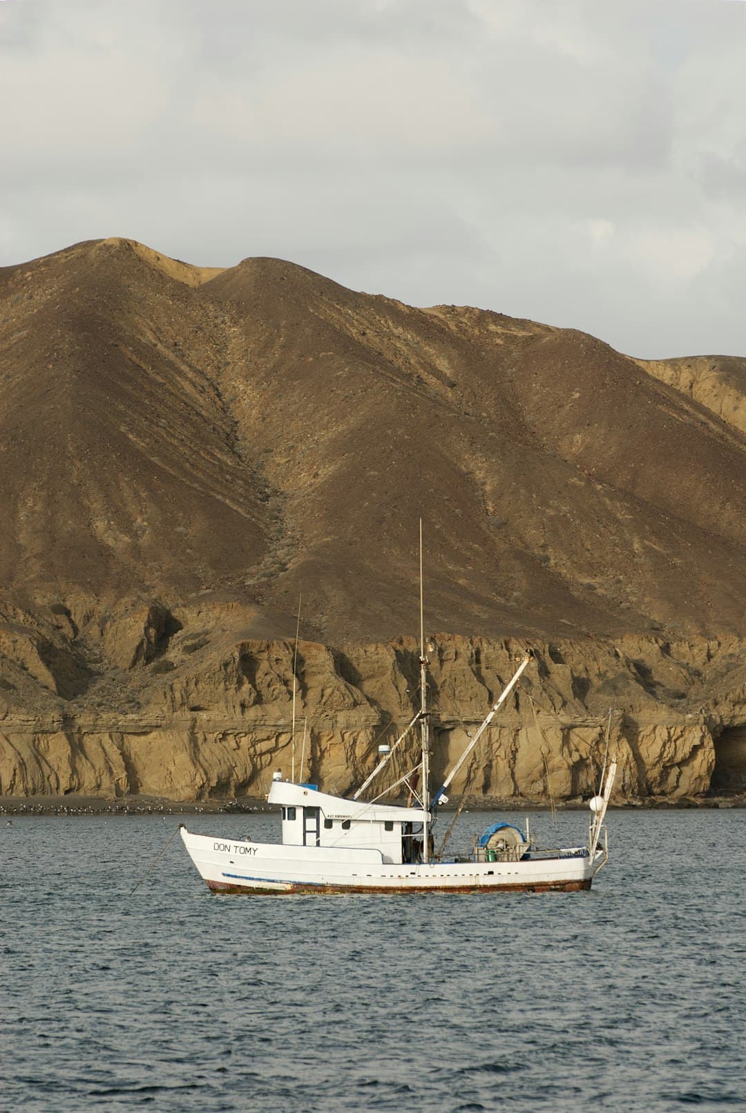 Fishing boat by mountain